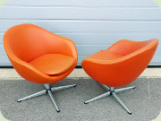 A pair of Swedish 60's
                          orange vinyl swivel base lounge chairs