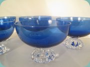 Dark blue dessert bowls with foot in
                          clear glass