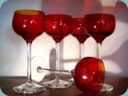 Wine goblets in red glass with clear
                          stem