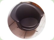 Black vinyl lounge
                          chair on swivel base