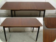 Swedish 60's teak
                          dining table with 2 leaves and black legs with
                          brass ends