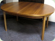 Swedish 60's oval
                          walnut dining table with extension leaf folded
                          under the table top
