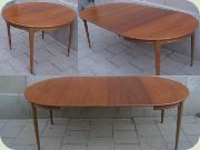 60's round walnut
                          dining table with extension leaves.