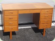 60's Swedish teak desk with four drawers
                          on each side and one in the middle