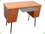 Teak desk with black
                          lacquered aluminum legs and leaf in Perstorp's
                          laminate