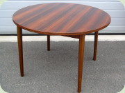 Swedish 60's Nils
                          Jonsson Troeds Malta round rosewood dining
                          table with 2 leaves stored folded under the
                          table top