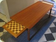 Teak coffee table with
                          reversible extension leaves, one with
                          chessboard. Danish design by Tove & Edvard
                          Kindt Larsen, made in Sweden by Seffle
                          Möbelfabrik.