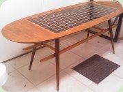 1950's Swedish oval
                          coffee table with tiles / mosaic and magazine
                          shelf.
