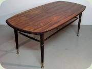 Swedish 60's rosewood
                          coffee table with magazine shelf