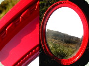 Oval red lacquered
                          wall mirror labeled Ota