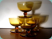 Ball stemmed cocktail glasses in a dark
                          amber shade