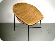 50's or 60's wicker
                          chair on black lacquered metal base